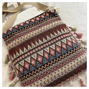 Detailed view of bohemian jacquard crossbody bag with colorful tassels and woven texture