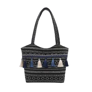 Ethnic bohemian tote bag in black and white stripes with colorful tassels and fringe