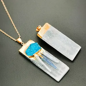 Detail of a white selenite rectangular pendant with blue kyanite cluster in rose gold