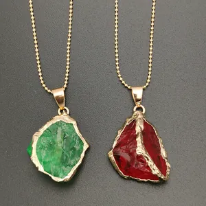 Detail of irregular raw crystal pendants with gold plated edges on beaded ball chains