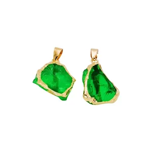 Detailed view of irregular green natural stone pendants with gold plated brass edges
