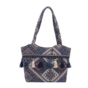 Ethnic knit tote bag with geometric diamond patterns and colorful tassel charms