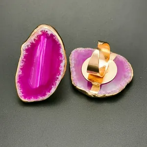 Detail of a natural purple agate slice ring with gold plating and adjustable band