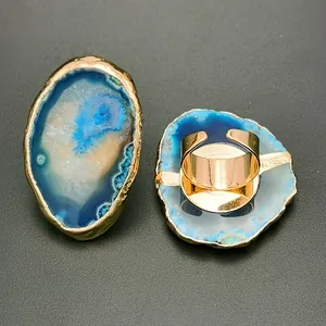 Detail of irregular blue agate ring with golden trim and adjustable metal band