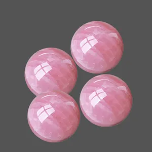 Polished natural rose quartz crystal spheres with internal ice crack and mist texture