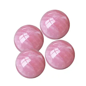 Detail showing four polished natural rose quartz spheres with internal icy textures