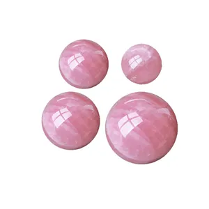 Macro detail of four polished natural rose quartz spheres showing internal textures