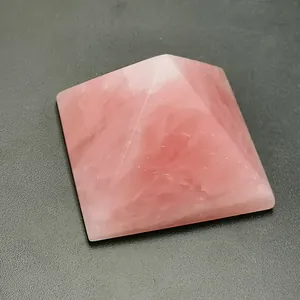 Macro view of a polished rose quartz pyramid showing natural healing crystal textures