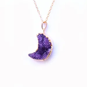 Detailed view of crescent moon purple druzy quartz pendant with gold plated edges