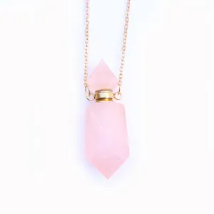 Macro detail van de rozenkwarts kristallen parfumfles hanger met gouden ketting