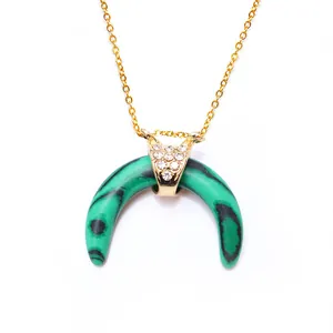 Macro view of green horn pendant with gold hardware and sparkling zircon accents