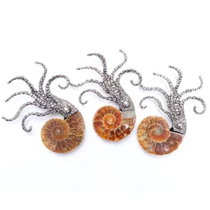 Macro shot of ammonite fossil pendants with vintage silver octopus style metalwork