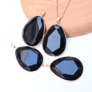 Detailed view of faceted teardrop amethyst pendants with elegant gold plated copper edges