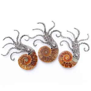 Macro shot of silver octopus tentacles holding a natural ammonite spiral fossil pendant
