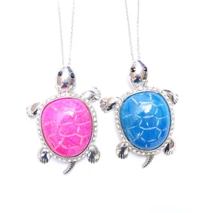 Detail of cute turtle pendant necklaces with pink and blue agate stones and crystals