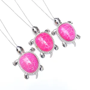 Detail of rose pink agate turtle pendant with white rhinestones on silver chain