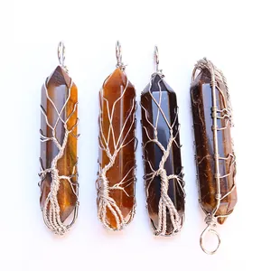 Detail view of tiger eye hexagonal crystal pendants with silver wire-wrapped tree of life