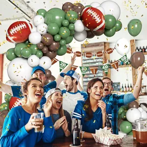 Detail of rugby party balloon arch kit with foil footballs and yardage themed banners