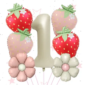 Detail of strawberry balloons, daisy flowers and beige number 1 balloon for first birthday