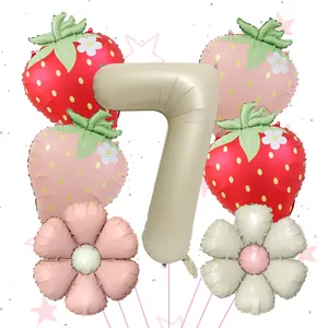 Detail of strawberry and daisy foil balloons set with cream number 7 for birthday party