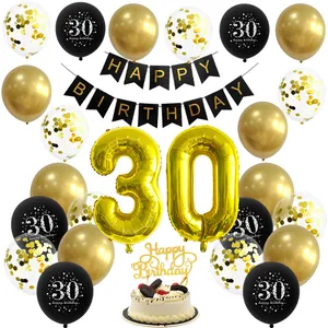 Macro detail of black and gold 30th birthday decoration set with balloons and banner