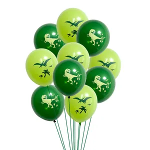 Detail of green latex balloons with T-rex and palm tree silhouettes for dinosaur party