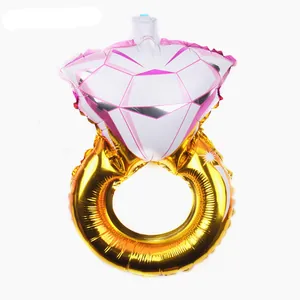Detail view of a large diamond ring shaped aluminum foil balloon with golden band finish