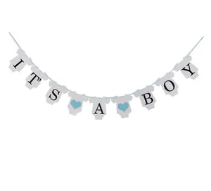 Detailed view of baby blue and white 'IT'S A BOY' banner for newborn party decoration