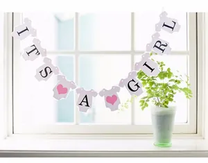 Detail of 'IT'S A GIRL' baby shower banner with pink hearts and baby bodysuit cards