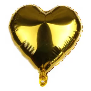 Close-up of heart-shaped gold foil balloon with metallic finish and inflation valve