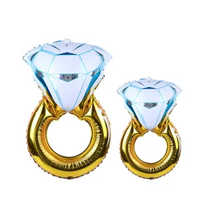 Detail of two gold diamond ring foil balloons in large and small sizes for wedding decor