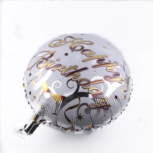 Silver foil birthday balloon with Happy Birthday text, gold stars and champagne glass