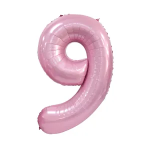 Detail of a large pearlescent pink foil number 9 balloon for birthday party decoration