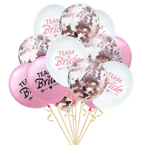 Close-up of Team Bride balloons with rose gold confetti and ribbons for wedding decor