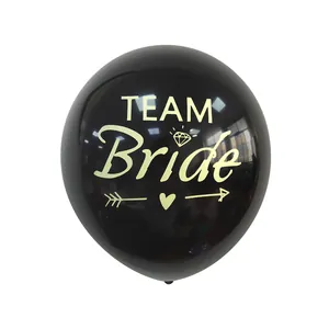 Close-up of black latex balloon featuring gold Team Bride text and diamond icons