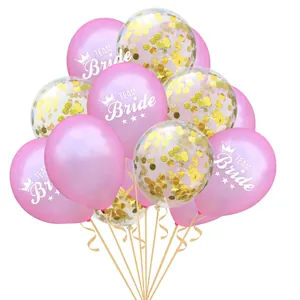 Close-up of pink Team Bride balloons with gold confetti and ribbons for wedding parties