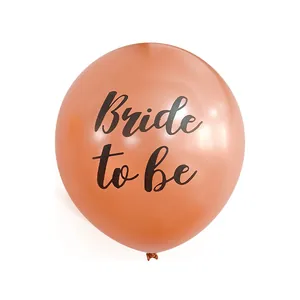 Detail of rose gold latex balloon with black Bride to Be script for bridal shower decor