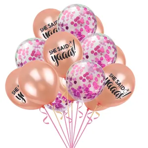 Detail of rose gold party balloons with SHE SAID yaaas text and pink confetti filling