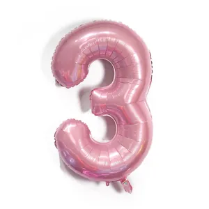 Macro detail of the light pink metallic number 3 balloon with iridescent foil texture