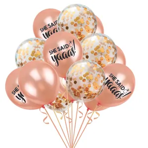 Detail of rose gold wedding balloons with She Said Yaaas text and confetti fillers