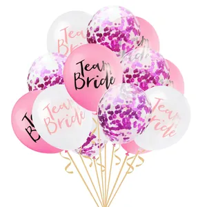 Close-up of Team Bride balloons in rose gold confetti and pink with golden ribbons
