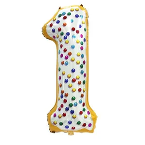 Detail of 40-inch number 1 donut balloon with golden finish and colorful sprinkles