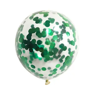 Close-up of clear latex balloon filled with green round foil sequins for party decoration
