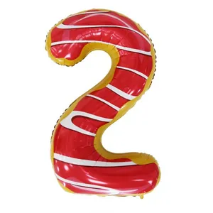 Detail of a number 2 donut shaped foil balloon with red frosting and white stripes