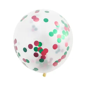 Close-up of clear latex balloon filled with festive red and green round confetti sequins