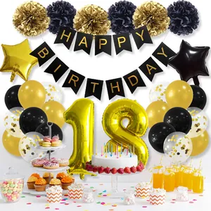 Detail of 18th birthday party decor set with gold and black balloons and paper pom poms