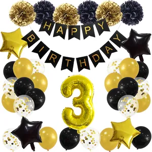 Flat lay of black and gold 3rd birthday party set with balloons and happy birthday banner