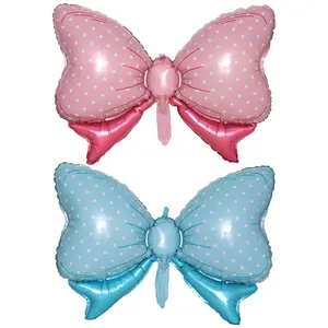 Close-up of pink and blue polka dot bow-shaped foil balloons for party decoration