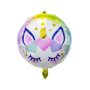 Detail of round unicorn foil balloon featuring macaron gradient and golden spiral horn