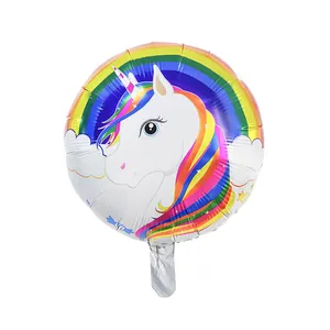 Detail of round unicorn foil balloon with rainbow patterns for birthday party decor